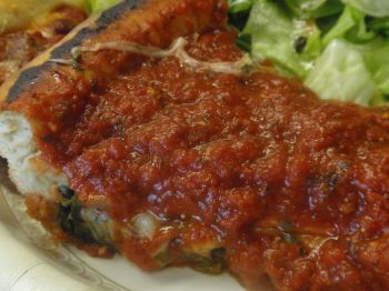 Delicious stuffed spinach pizza!  I am guessing about 540 calories, 27 fat and 49 carbs for this slice?  Am I way off?